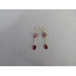 A pair of garnet and white hardstone earpendants, each hook suspending an articulated line with