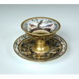 A 19th century Paris porcelain footed cup and stand, unusually decorated with an 'agate' ground body
