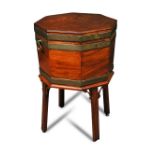 A George III octagonal mahogany and brass bound wine cooler, with brass side carrying handles, a