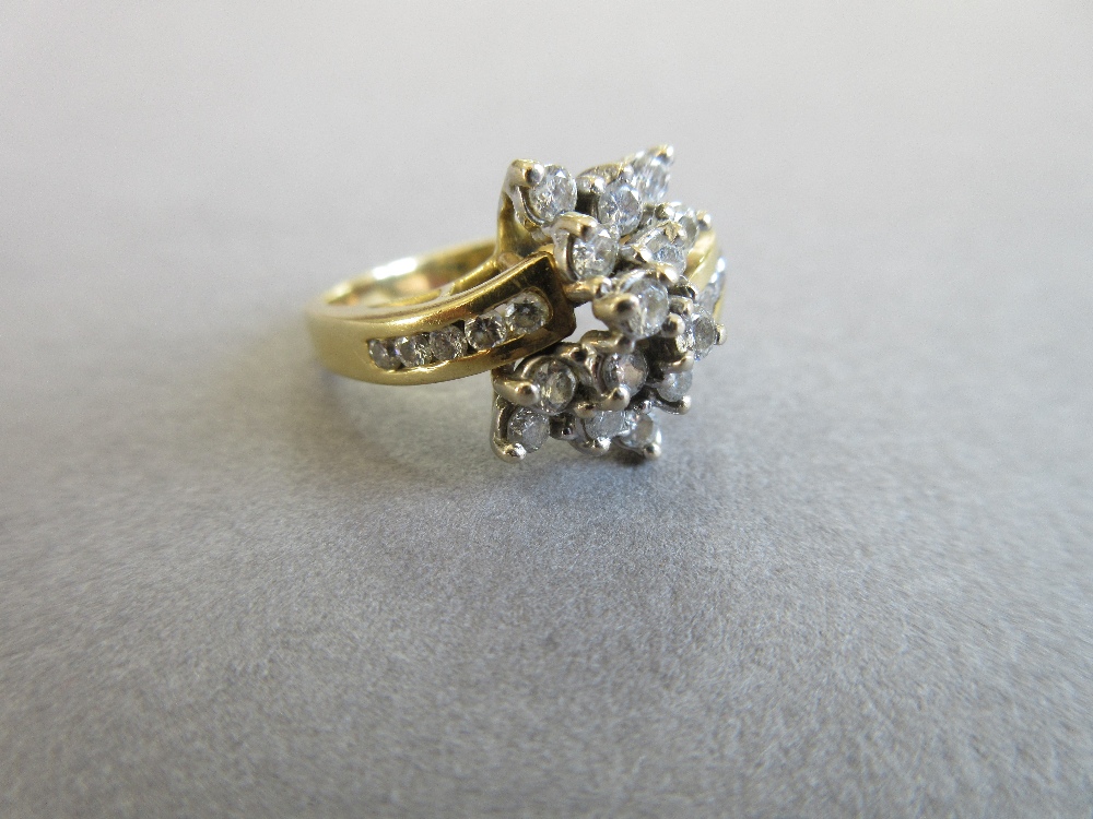 An asymmetrical diamond cluster ring, with a pierced bow form composed of tiered round brilliant cut - Image 2 of 5