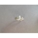 A marquise cut diamond ring, the principal stone in a raised claw setting between round brilliant