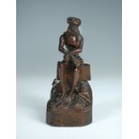 A small late 18th or early 19th century carved wood figure of Christ, his barely draped body sitting