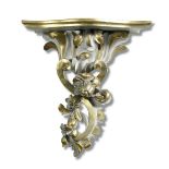 A pair of 19th century parcel gilt carved wood wall brackets, circa 1830, the shaped tops of foliate