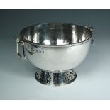 A George V silver punch bowl, by Mappin & Webb, London 1936, with hammered body and two hinged