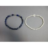 A lapis lazuli bead necklace together with a freshwater cultured pearl necklace, the first made from