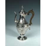 A George III silver coffee pot, Sheffield 1777, the baluster body later embossed with foliage and