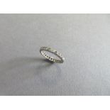 A diamond full hoop eternity ring, the continuous line of single cut diamonds in unmarked white