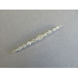 An early 20th century diamond bar brooch cased by Asprey, designed as a long graduated line of