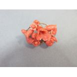 A carved coral flower spray brooch, of oval outline and composed of individually wired elements,
