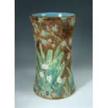 A George Jones Majolica umbrella stand, naturalistically moulded as a tree trunk with daisies, ferns