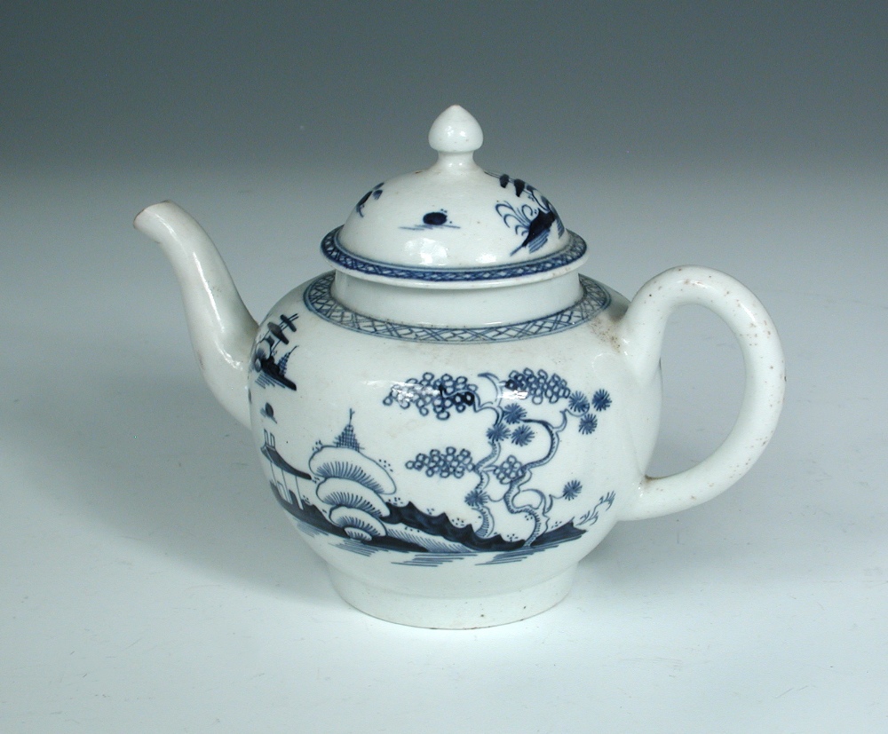 A Lowestoft blue and white tea pot and cover, circa 1770, the shouldered globular body decorated