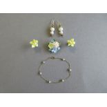 A painted porcelain flower brooch and earring suite together with a gold and cultured pearl bracelet