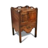 A George III mahogany tray top night cupboard, with a galleried top and decorated outline panelled