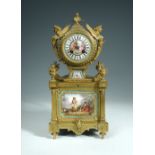 A French 19th century ormolu and porcelain mantel clock, the drum head flanked by twin winged female