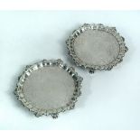 A pair of George II silver waiters, London 1755, the field engraved to the centre with a family