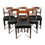A set of six Regency mahogany dining chairs, with inlaid bar backs and pierced florette carved