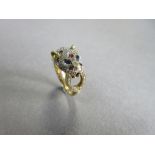 A gemset leopard head ring, the big cat's head millegrain set throughout with small round