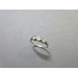A three stone diamond ring, the three slightly graduated round brilliant cut diamonds simply claw