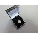 A gold and diamond set heart shaped pendant with chain, the white gold heart pavé set with round