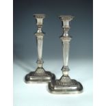 A pair of George III silver neo-classical candlesticks, by John Roberts & Co, Sheffield 1807, with