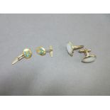 A pair of turquoise set horseshoe cufflinks together with a pair of mother-of-pearl set cufflinks,