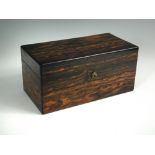 A 19th century coromandel wood tea caddy, the hinged lid opening to reveal a central cut glass
