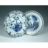 Two 18th century Delft blue and white chargers, one decorated to the centre with a garden scene with