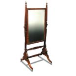 A Regency mahogany framed cheval glass, of small proportions, with urn finials, on splayed
