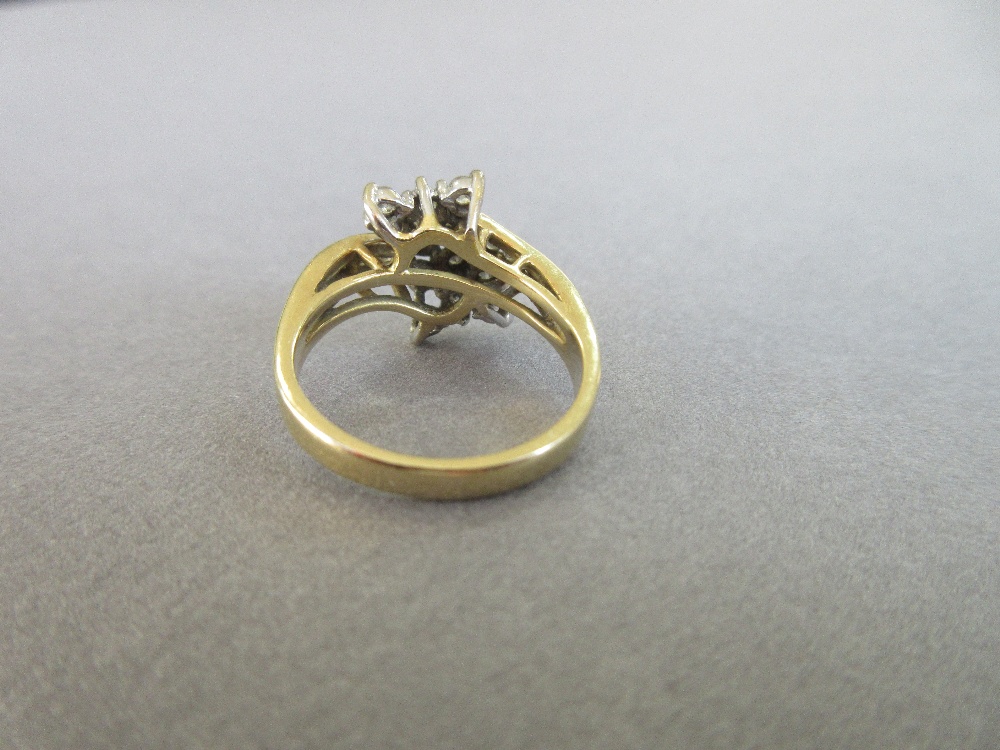 An asymmetrical diamond cluster ring, with a pierced bow form composed of tiered round brilliant cut - Image 4 of 5