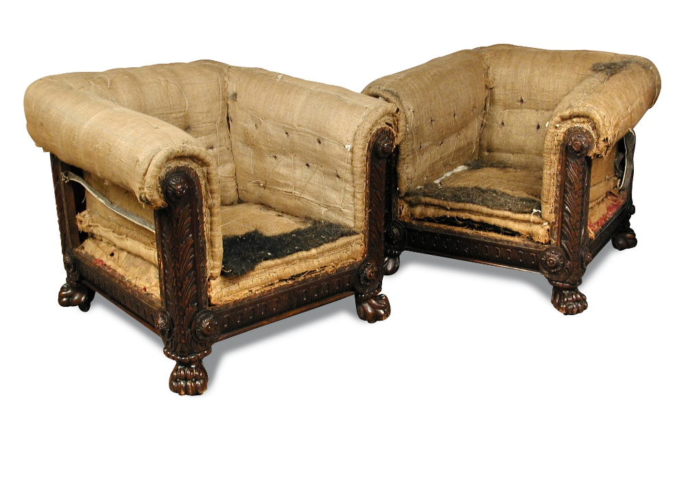 A pair of late Regency mahogany upholstered library chairs, the square back frames carved on all