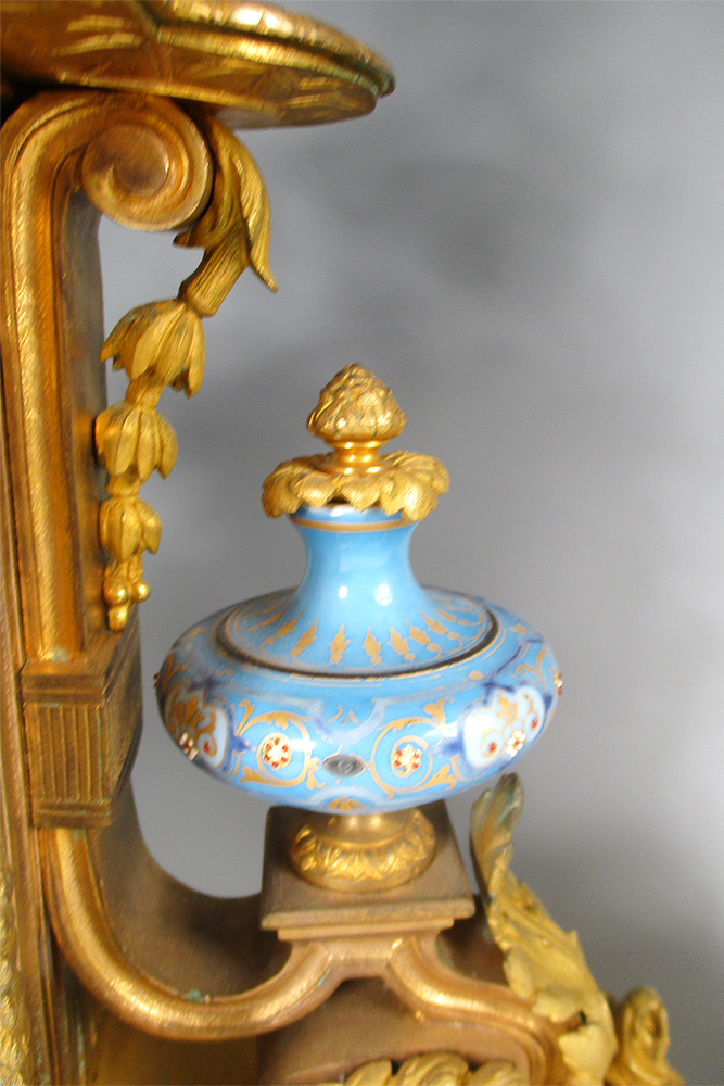 A 19th century French gilt metal and 'Sevres' porcelain clock garniture, the elaborate shaped case - Image 5 of 14