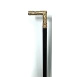 A late 19th century precious yellow metal mounted walking cane, tests as 14/15ct gold, the