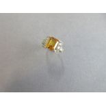 A synthetic yellow sapphire and diamond dress ring, the emerald cut golden yellow sapphire four claw