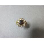 A 19th century garnet and white hardstone ring, the oval cut garnet crimp collet and closed back set