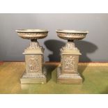 A pair of Regency style bronze tazza, the urn tops cast with grape vine borders and raised on square