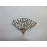 A vintage diamond fan brooch, the eleven leaves set with graduated lines of rose cut diamonds to a