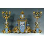 A 19th century French gilt metal and 'Sevres' porcelain clock garniture, the elaborate shaped case