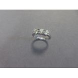 A three stone diamond ring set in 18ct white gold, the three uniform round brilliant cut diamonds