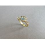 A modern 18ct gold diamond and aquamarine 'rising sun' ring, designed as an oval cut aquamarine