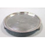 A George IV silver waiter, by William Burwash, London 1821, circular with gadrooned edge, raised