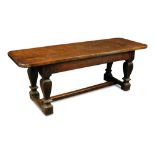 An oak refectory table - 17th century, the plank top with re-entrant shaped corners, on square