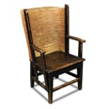 A small Orkney stained pine framed armchair - 20th century, with basket weave back, on stretchered