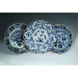 An 18th century Delft blue and white charger, the centre decorated with two cockerels and insects in
