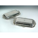 A pair of George VI silver rectangular two handled entree dishes and covers, by Mappin & Webb,