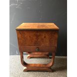 An Art Deco walnut work table, the hinged top opening to reveal a silk lined interior with drawer