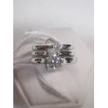 Three single stone diamond and platinum rings, the first a round brilliant cut diamond estimated