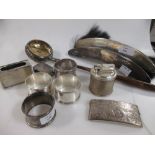 A Victorian card case of curved outline, four numbered napkin rings, a toddy ladle, a silver cased