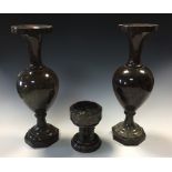 A pair of polished marble vases and a miniature font, the baluster vases with flared rims and