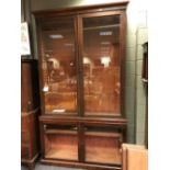 A 19th century glazed mahogany bookcase with adjustable shelves and cupboards beneath, 260cm x 150cm