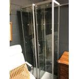 A pair of freestanding glass display cabinets, 198 x 40 x 40cm (2) VAT is payable by the buyer at